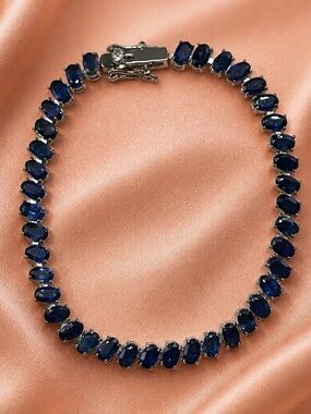 Blue Sapphire Tennis Bracelet set in rhodium over 925 Sterling Silver. 7”. NEW!